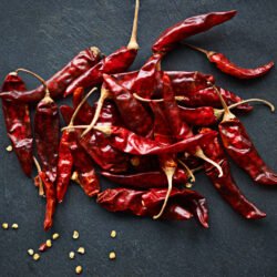Increase the heat. High angle shot of dried red chillies on a kitchen counter